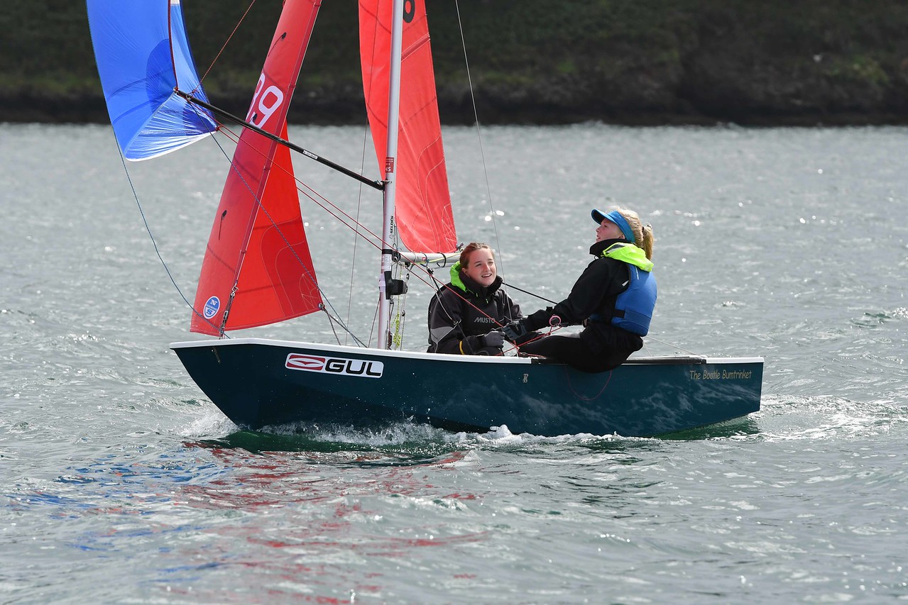 A blue/green Mirror being raced by  two girls